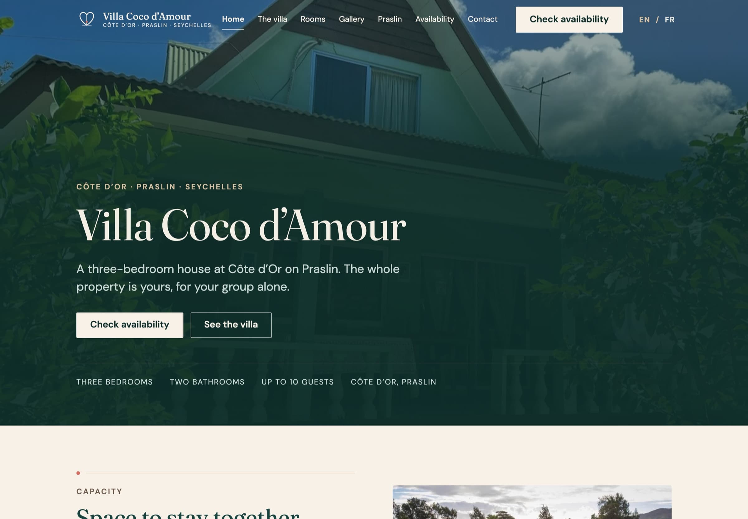 The Villa Coco d’Amour home page on a desktop screen: the property name over a photograph of the green timber house, the opening description, both calls to action, the full navigation and a strip reading three bedrooms, two bathrooms, up to ten guests